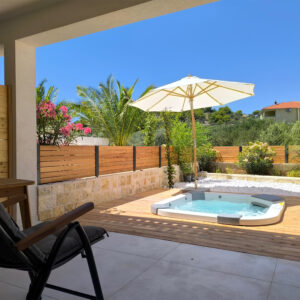 View of outside jacuzzi from shadow covered terrace